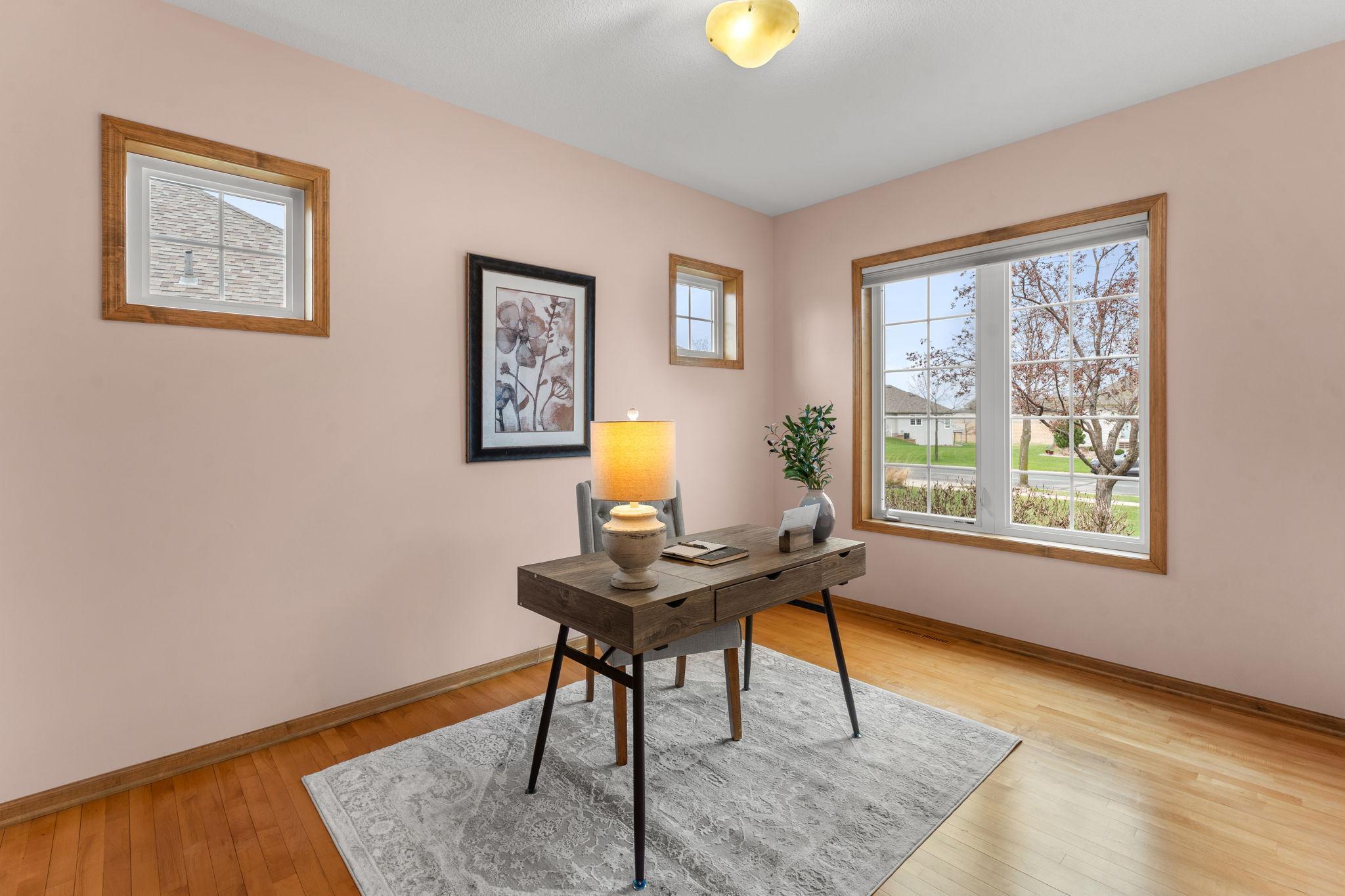 Bedroom two also features a large front-facing window, filling the space with natural light and offering peaceful neighborhood views.