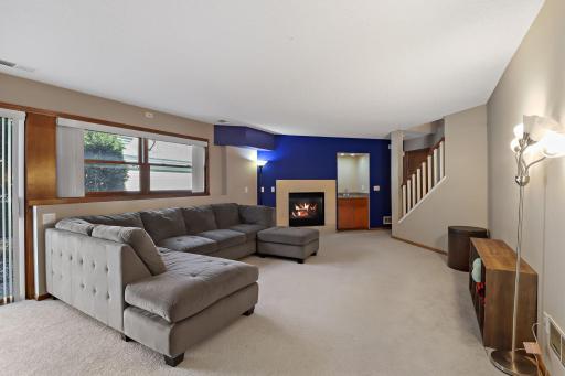 Bright & open family room with fireplace.