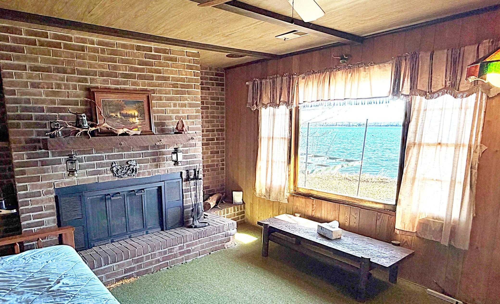 Living room with Lake Views and Brick Fireplace.jpg