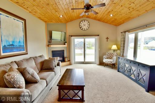 Living room with gas fireplace and patio door out to the deck overlooking the fenced in yard!