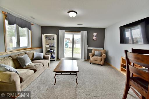 Lower level family room with patio door leading to a small patio area and fenced in backyard!