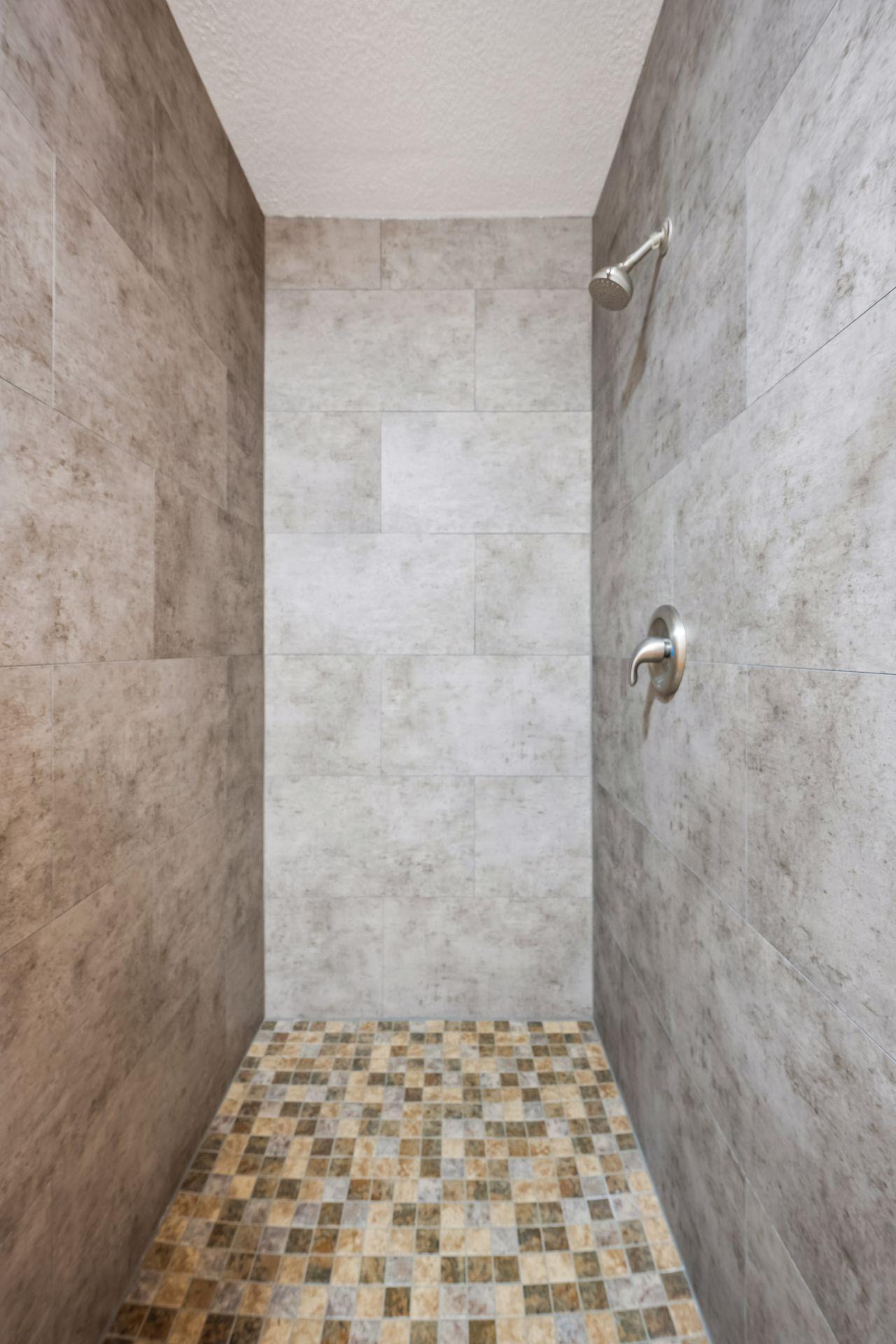 Floor to ceiling tile walk in shower in lower level, basically like new.