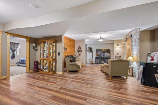 View of the lower level from back wall. Tall ceiling, additional bedroom, bathroom, storage room and more.