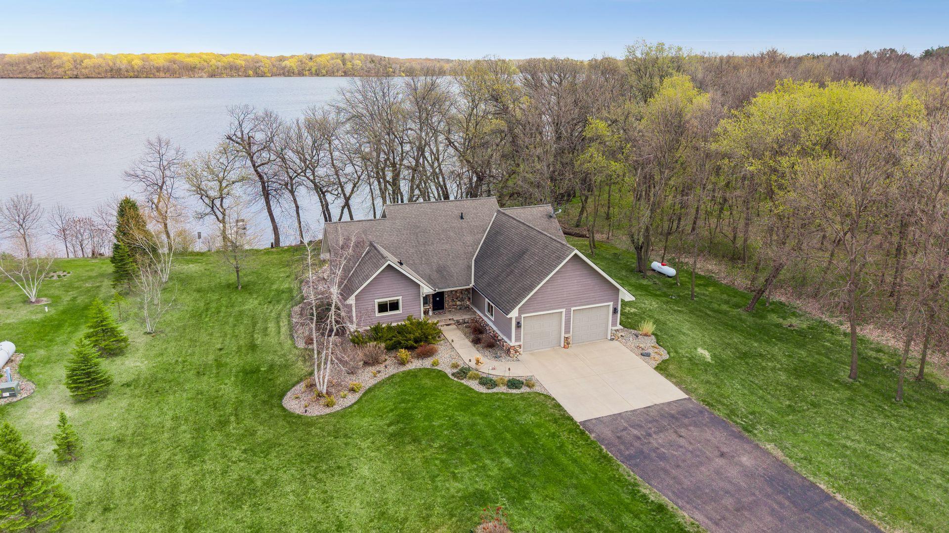 Aerial view 20568 746th Ave on 1.86 acres. 152ft of level lakeshore, featuring mature trees, manicured lawn, and peaceful waterfront setting. Enjoy nature views, privacy, and easy lake access ideal for year-round living or perfect close in cabin.