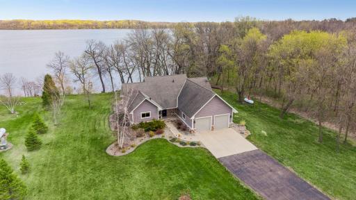 Aerial view 20568 746th Ave on 1.86 acres. 152ft of level lakeshore, featuring mature trees, manicured lawn, and peaceful waterfront setting. Enjoy nature views, privacy, and easy lake access ideal for year-round living or perfect close in cabin.