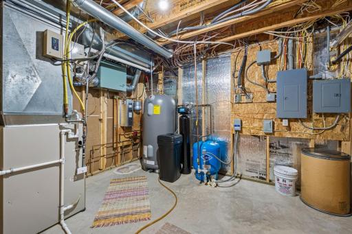 Mechanical room showing in floor heating, 85 gallon off peak water heater, water softener, and more. There is an additional room not pictured that can be a 5th bedroom or additional in home storage.