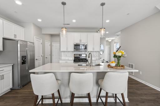 Beautiful stone countertops and white cabinets.