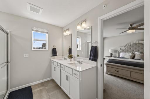 Primary suite bathroom with double vanity.
