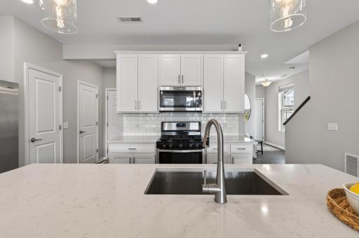 Large undermount sink built into kitchen island.
