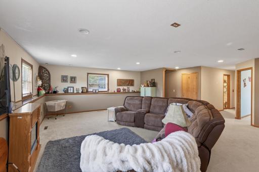 Recessed lighting and lookout windows ensure this lower level is bright and inviting.
