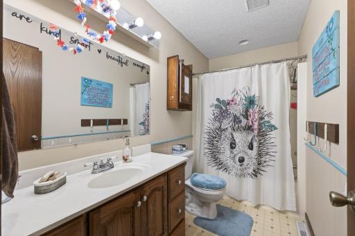The upper level bathroom is located near both secondary bedrooms, and its spacious layout makes morning routines a breeze.