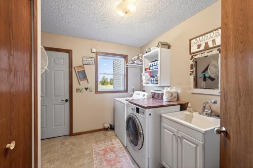 Main level laundry and 1/2 bath with walk-out access to the patio and backyard.