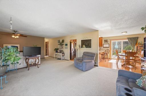 The upper level flows seamlessly from the living room into the informal dining area and kitchen and to three bedrooms, creating an easy, connected layout.