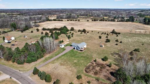 Situated on an expansive 5.95 acre lot with open space and tree-lined surroundings for added privacy.