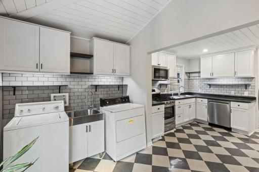 Just beyond the kitchen is the utility room with convenient laundry access