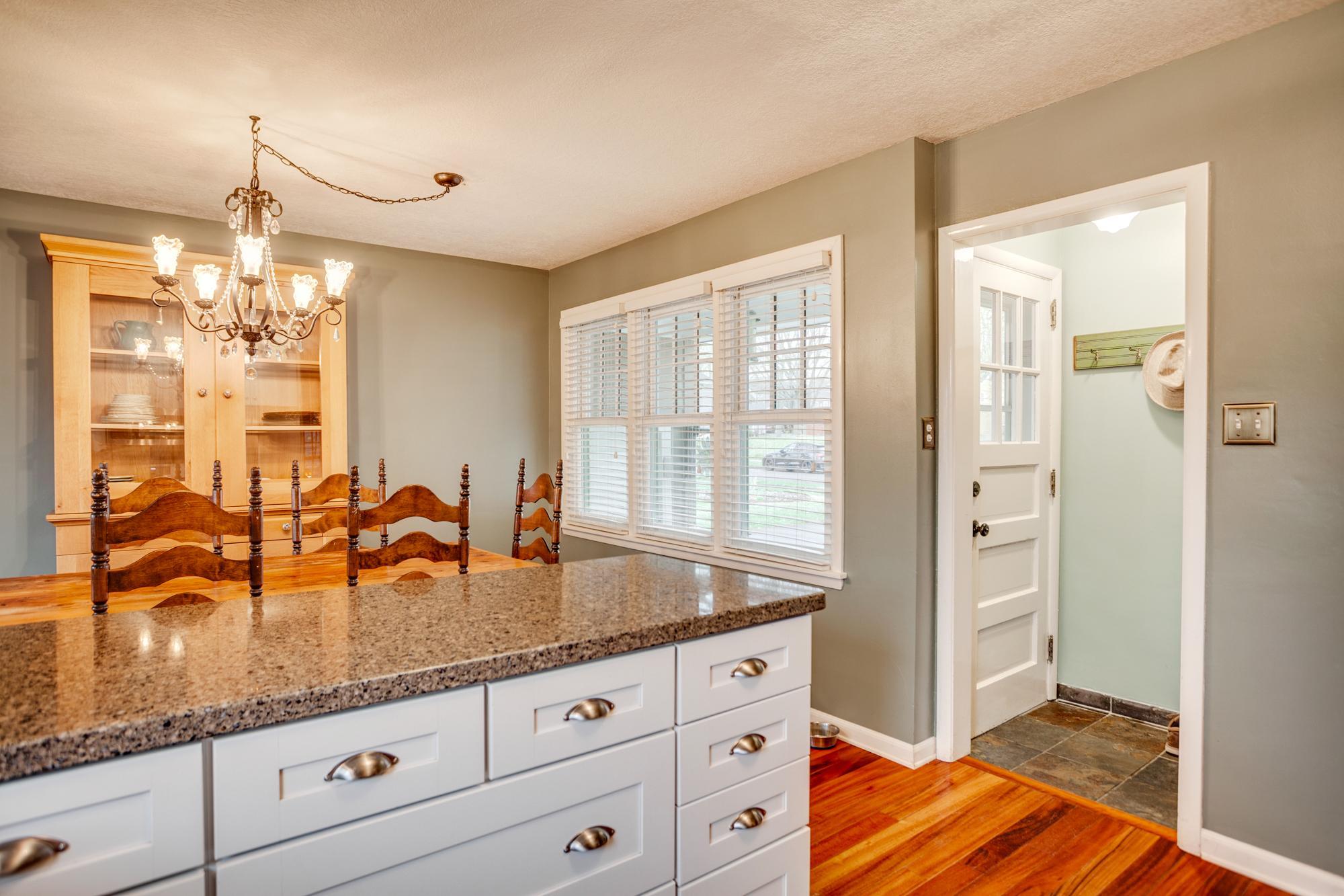 The kitchen/dining area offers access to both the front and back of the home, increasing its everyday functionality.