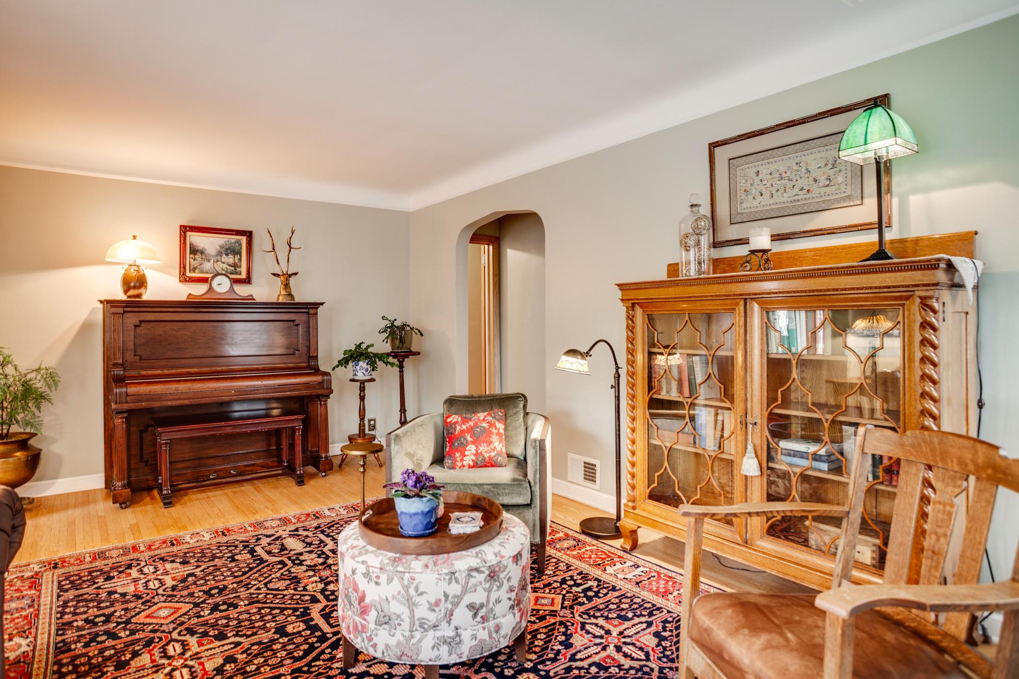 The main level showcases warm, inviting gathering areas highlighted by rich hardwood floors that flow seamlessly throughout.