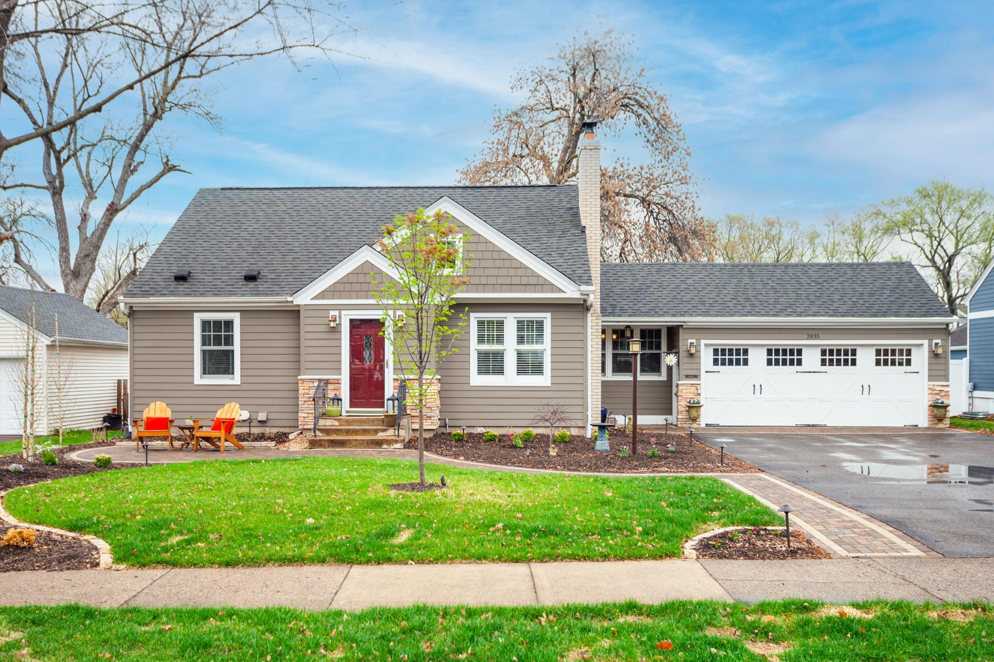 Modern cottage-style home with Cape Cod charm and exceptional curb appeal from the moment you arrive. Framed by a park-like front yard, the new paver walkway welcomes you & curves along the lush perennial gardens...perfect for coffee with neighbors.