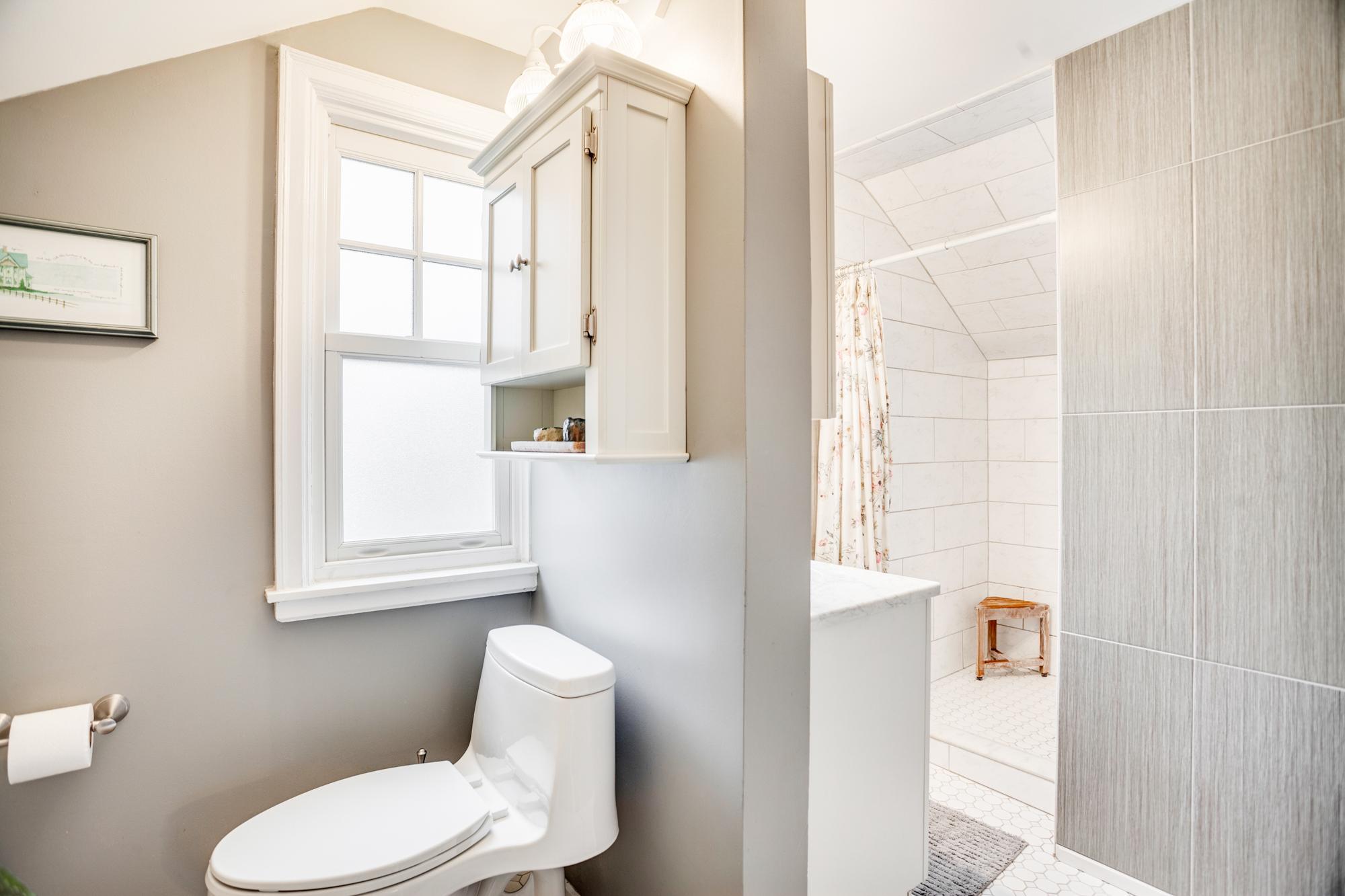 Completing the suite is a private three-quarter bath, beautifully wrapped in tile with a walk-in tile shower.