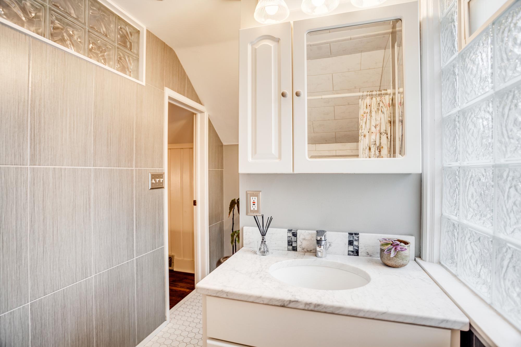 Glass block windows ensure natural light throughout the suite while maintaining privacy.
