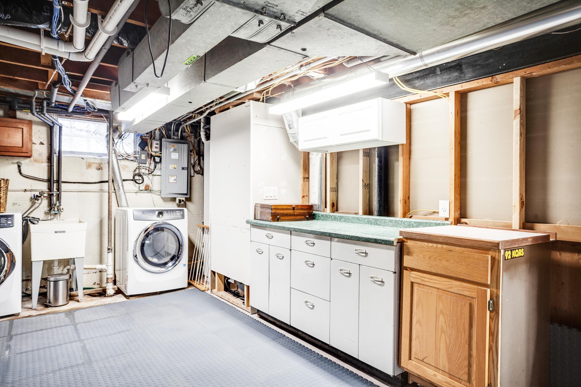 The huge storage room goes well beyond expectations, complete with laundry, mechanicals, a workbench, and extensive shelving to keep everything organized and easily accessible.