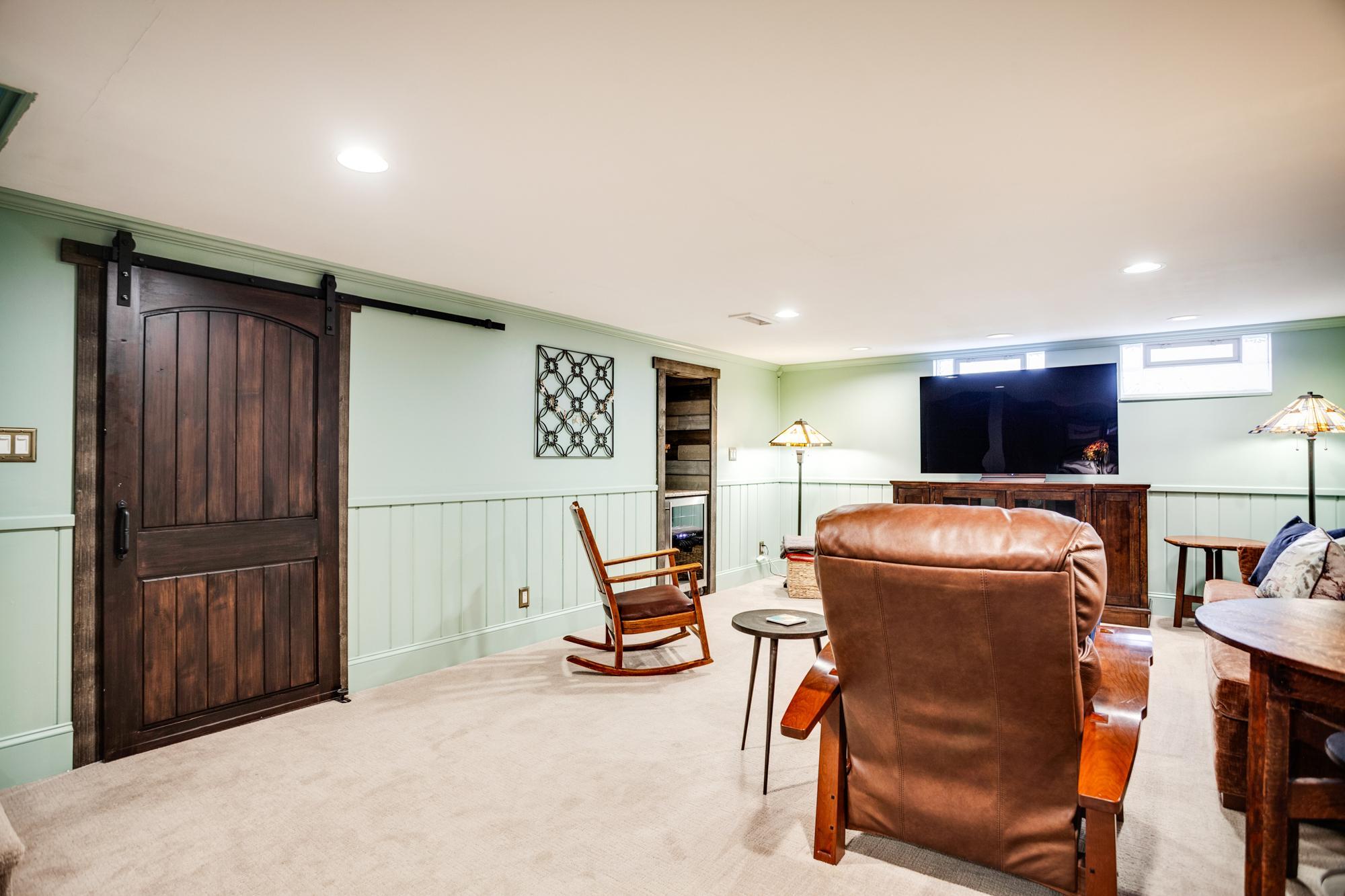 A gorgeous sliding barn door within this area leads to the oversized laundry/storage room.