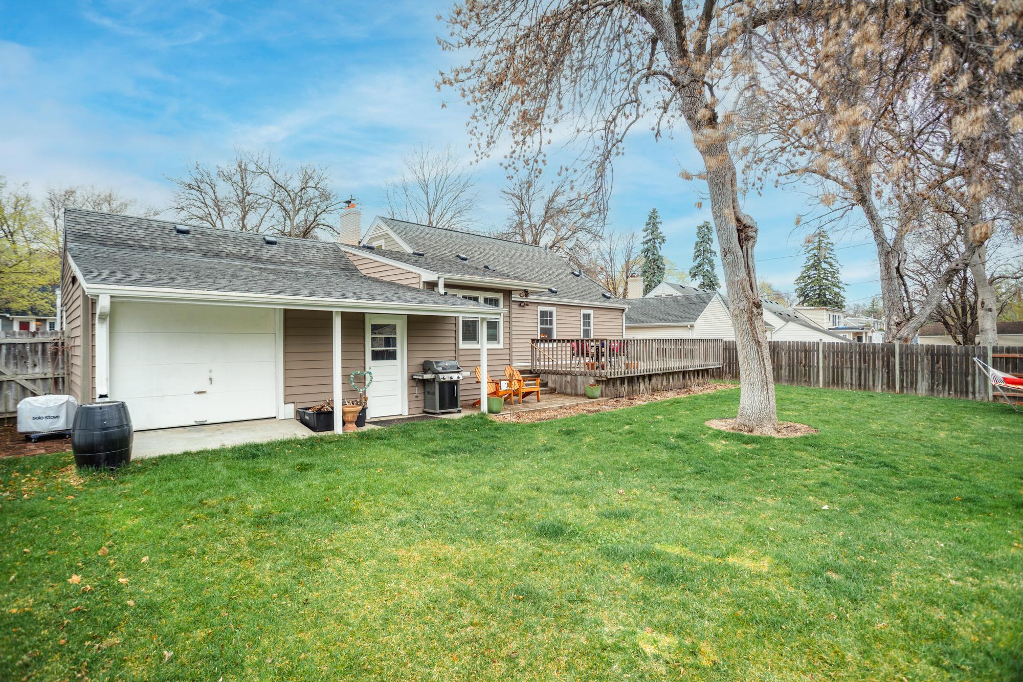 Adding to the versatility, the garage features a convenient pull-up door with direct access to the backyard, perfect for a workshop, storage, or easy movement of lawn equipment.