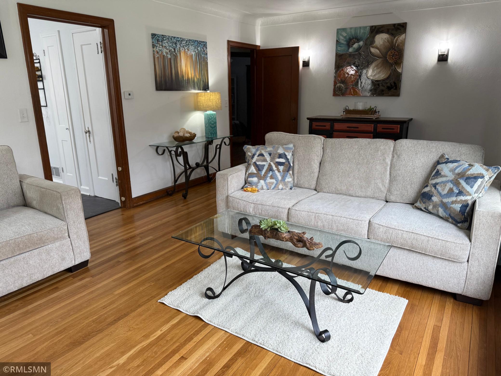 The living room is warm and inviting and also full of character. It’s spacious and showcases, beautiful hardwood floors and classic architectural detail details throughout.