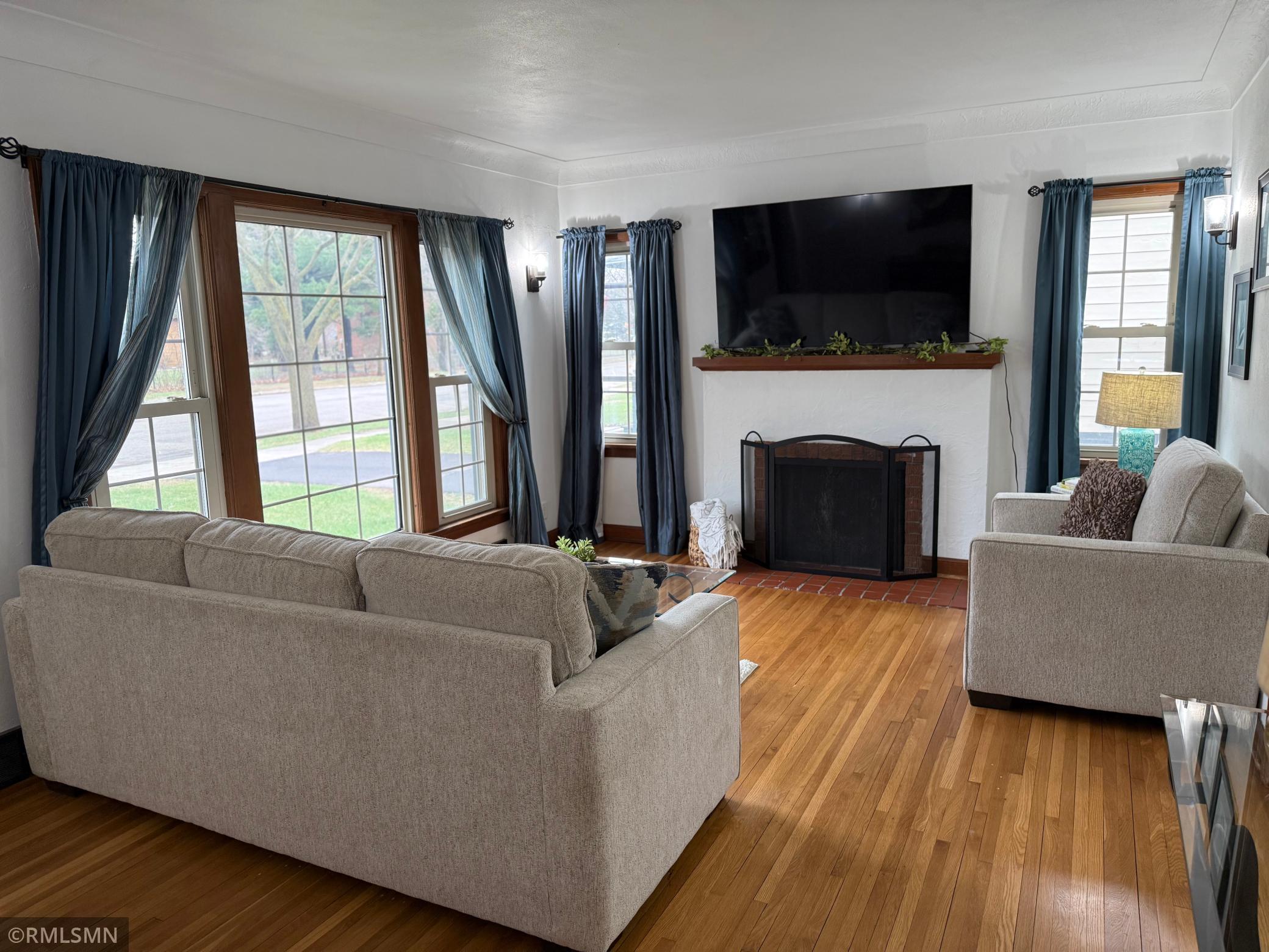The room offers plenty of space for comfortable seating and entertaining, highlighted by stylish, lighting accents and thoroughly designed wall features Rich, wood trim, adds warmth and contrast