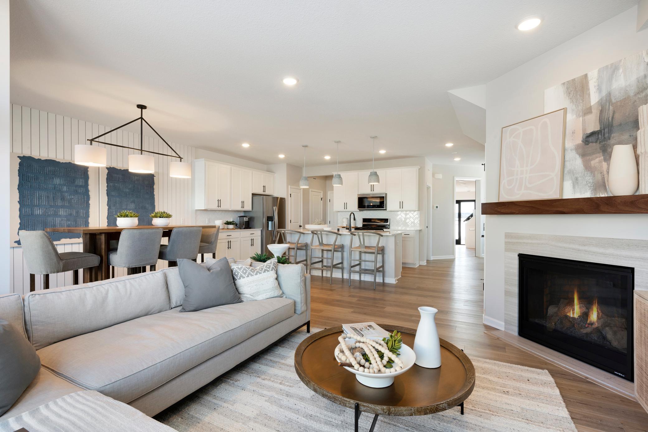 Come over to the living room perfect for any occasion! Both spacious and luxurious, this living room is perfect for any occasion! Photo of model home.