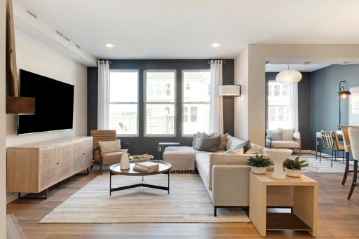 Soaring windows drench the living room in natural light! Photo of model home.