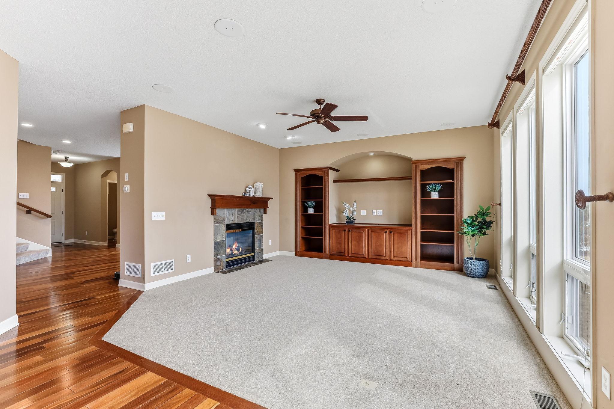 Living room with built in cabinets and two sided fire place