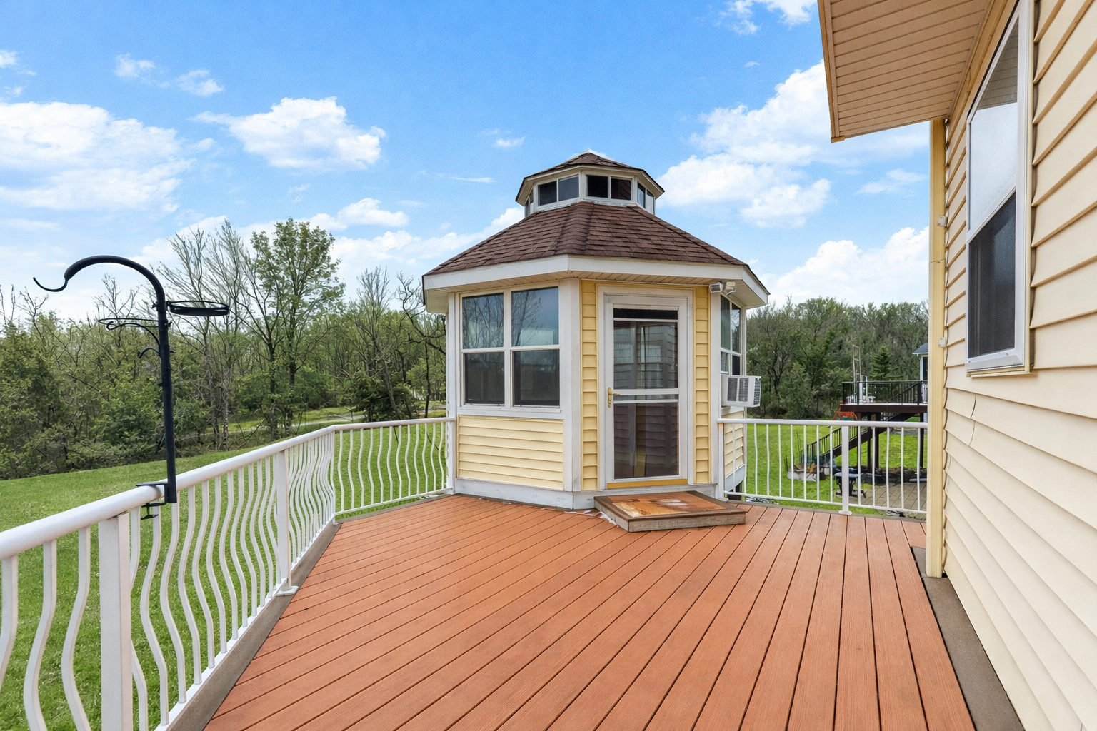 maintenance-free deck with stairs leading to the private backyard and pond