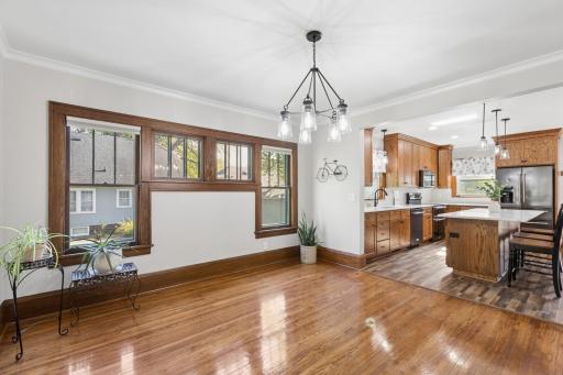 Dining room features more of the gorgeous hardwood floors and wonderful piano windows!