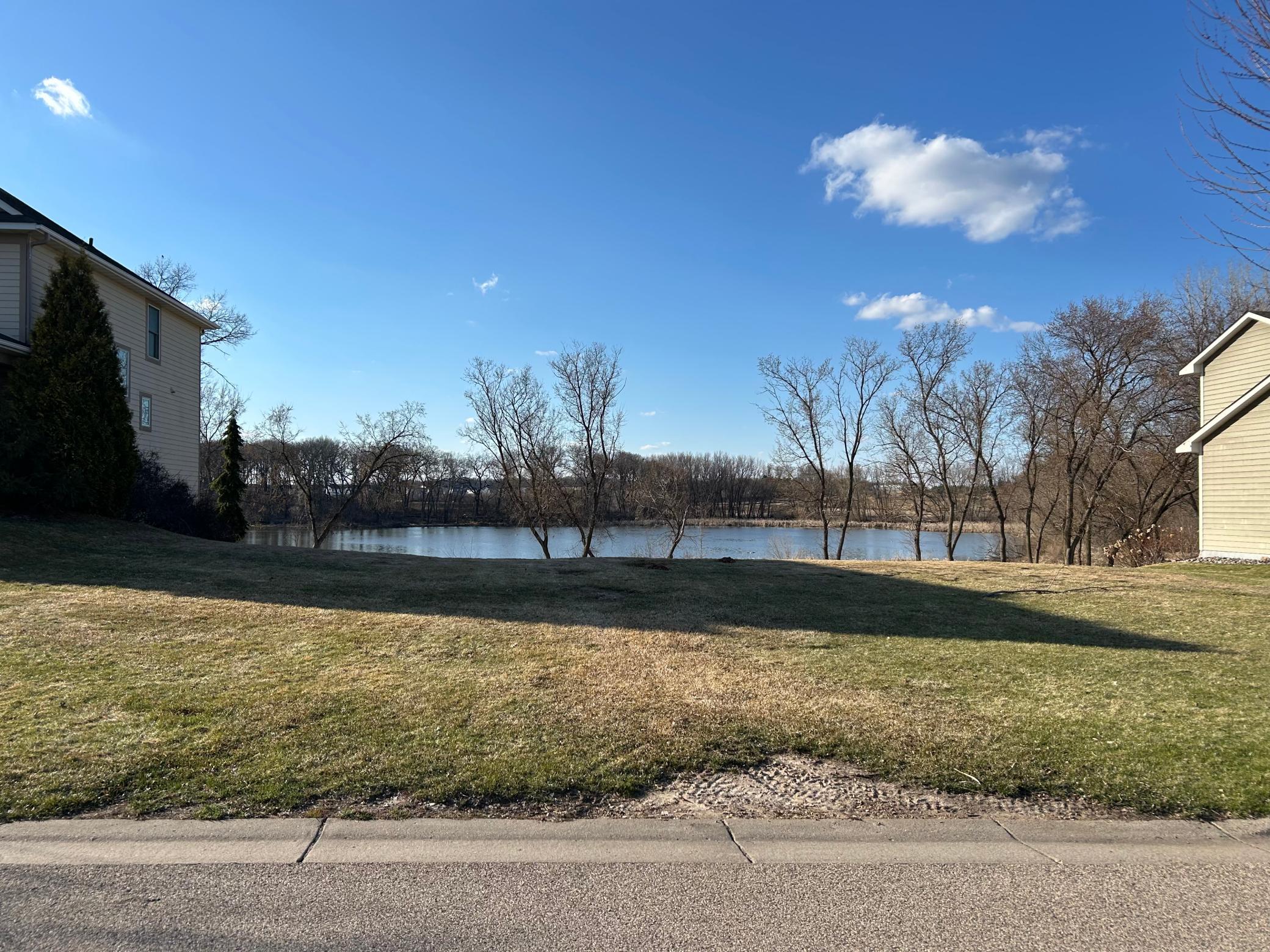 Rare waterfront buildable lot in Cottage Grove, MN — direct pond views from the street. Ready for your custom home. Eastridge school district. The last remaining lot in this established neighborhood. $249,000