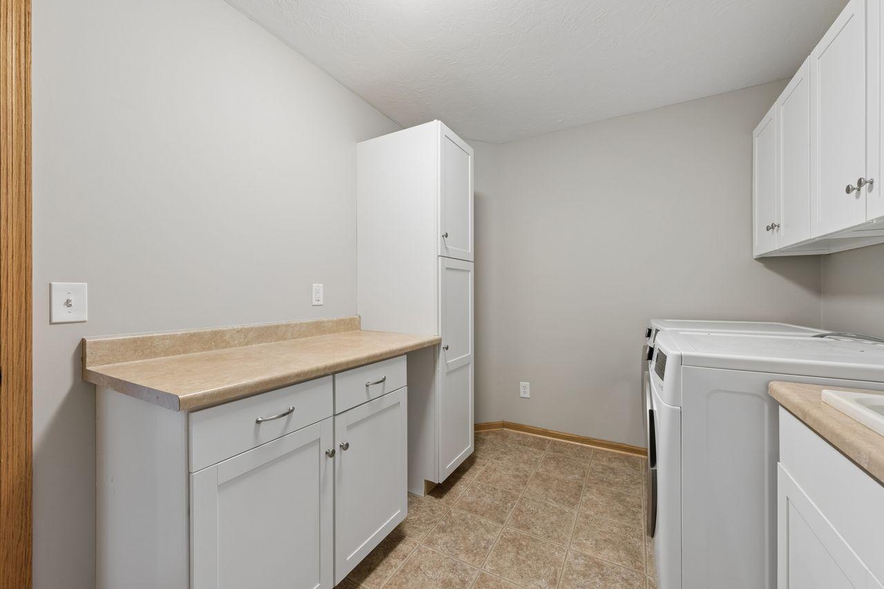 Additional storage and work space in the upper level laundry room.