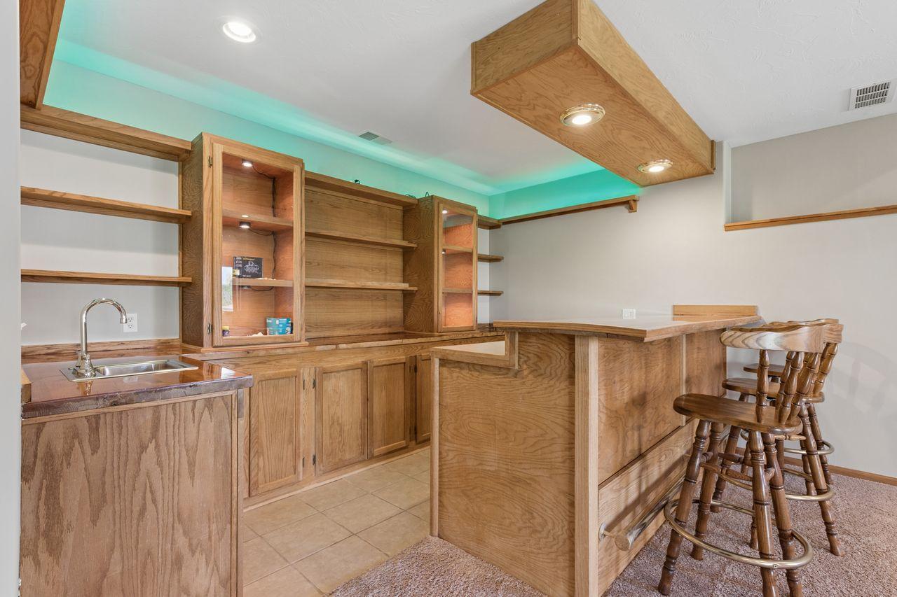 Lower level wet bar with built in shelving.