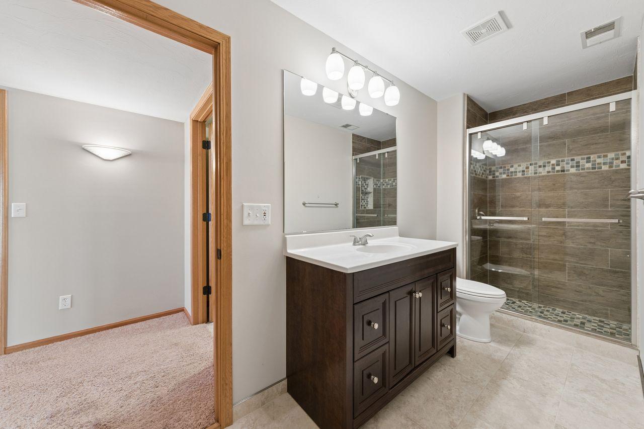 The lower level bath features a tiled shower.