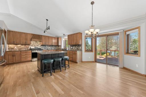 The updated kitchen features stainless steel appliances, a kitchen island and granite counters.