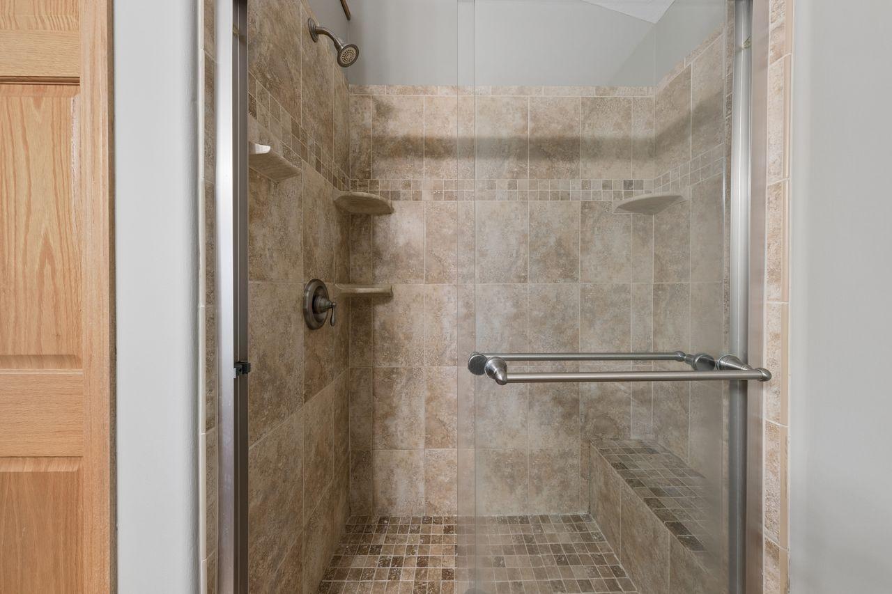 Owner's suite tiled walk in closet.