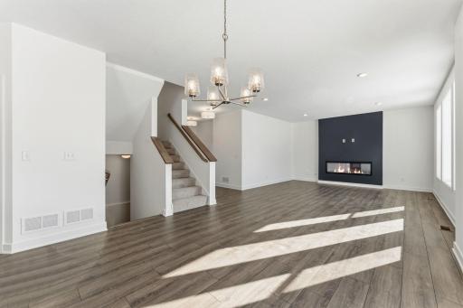 Gas fireplace with Luxury flooring on the main floor Living/Dining and Kitchen area.
