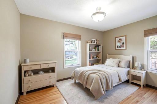The same second bedroom on main level includes gorgeous hardwood floors & millwork with large, daylight windows. This is virtually staged with neutral hues.