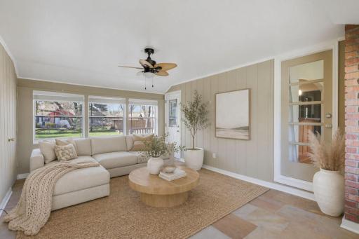 Same sunroom/breezeway is open & airy. Access from the front walkway, living room, kitchen, garage & deck. Large, square tile floors coordinate well w/ custom painting, white trim & fandelier. This is virtually staged as a lounging retreat.