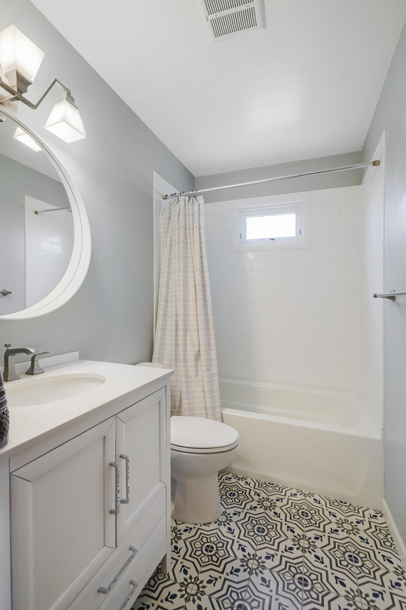 The bright and clean full bath with a gorgeous tiled floor is conveniently located on the main level.