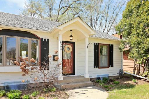 Esthetically- pleasing to the eye with its architectural details. The black accents contrast nicely against the white LP Smart-siding. The black lantern-style light highlights the arch that preludes the arch in the kitchen inside.