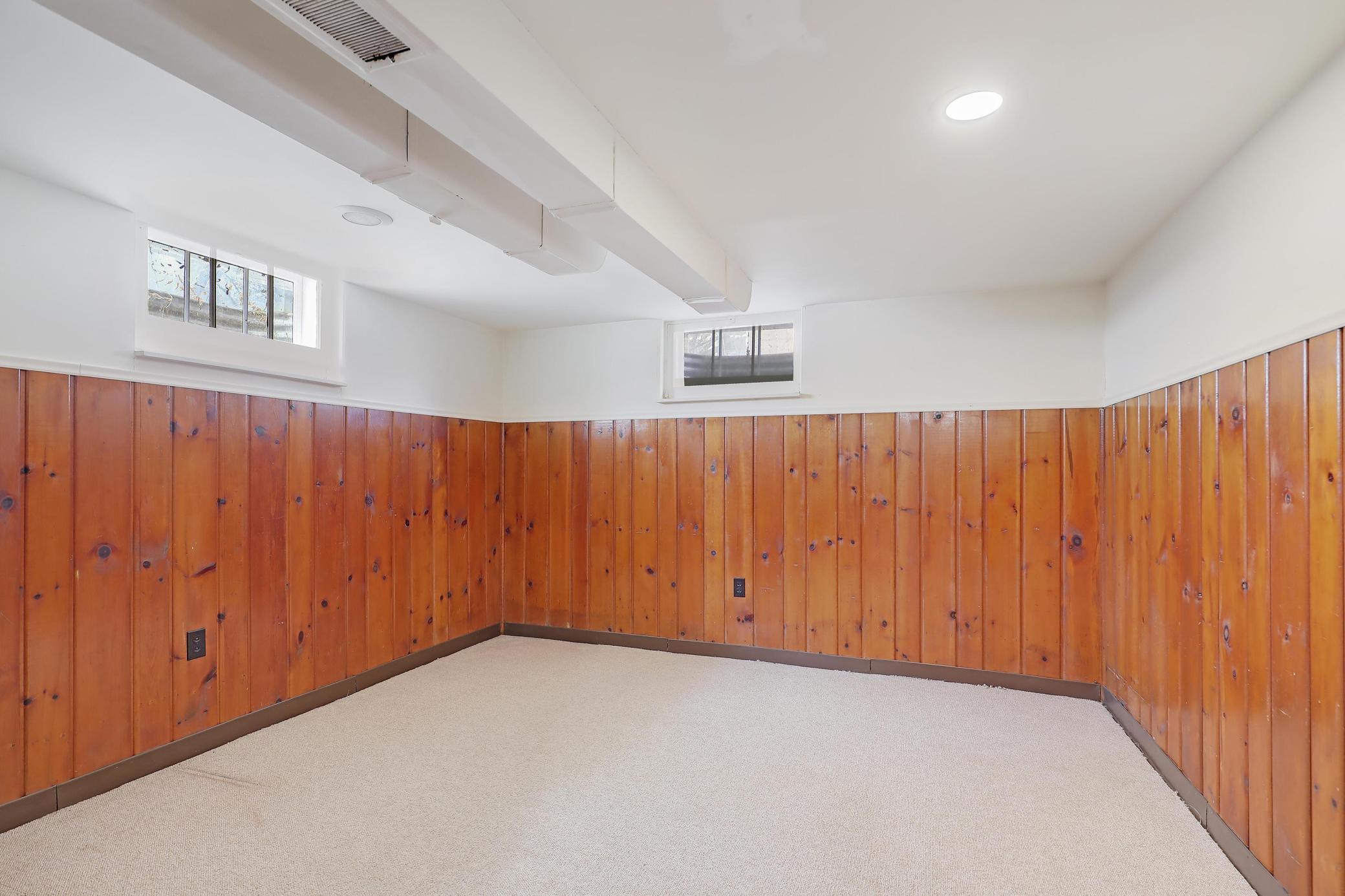 Bonus room with wood paneling.