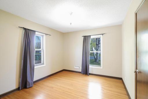 The 2nd bedroom features hardwood floors, 2 large windows with drapery for privacy and light-blocking.