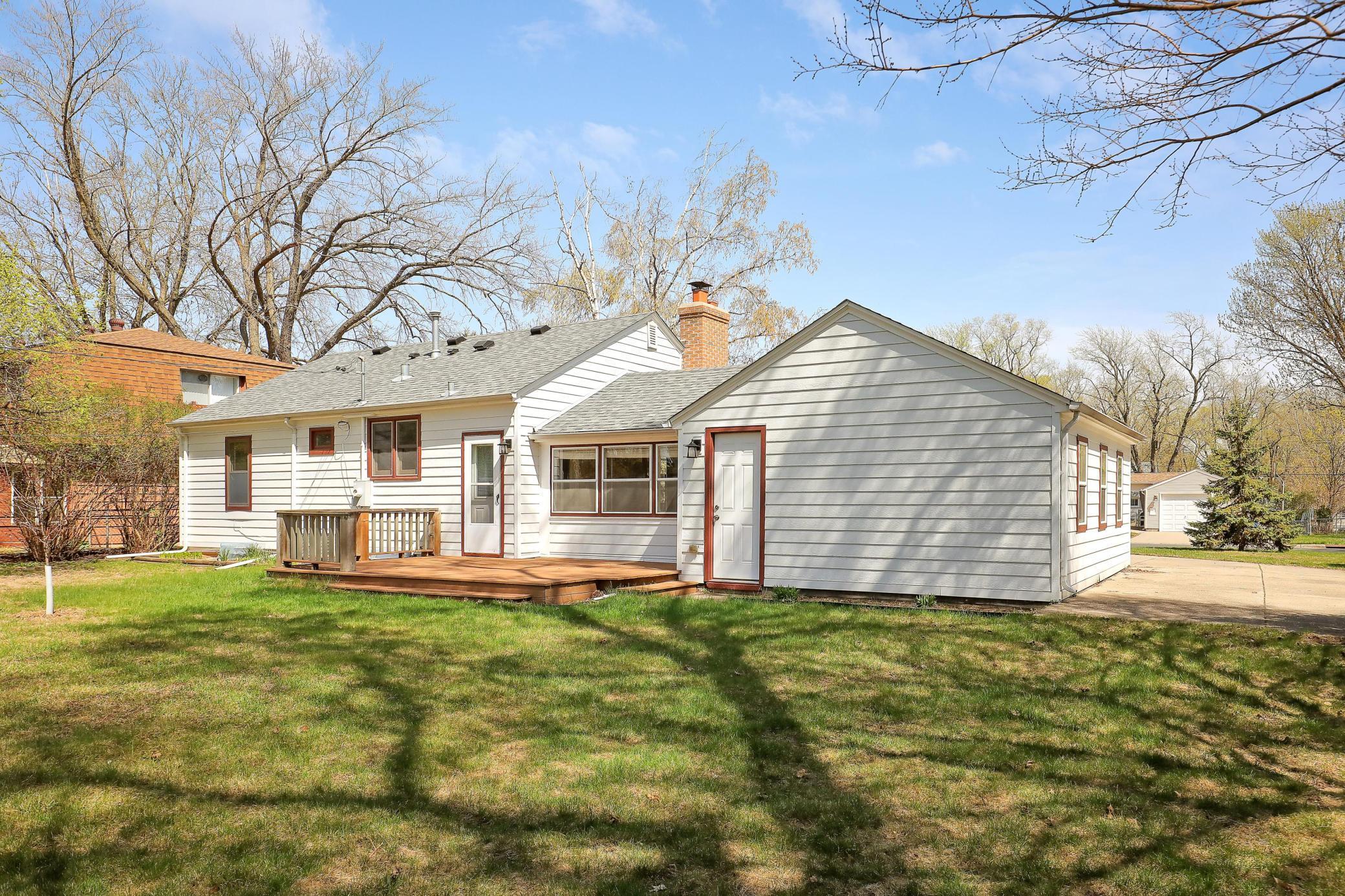 Rear exterior of home with nice white engineered wood siding replaced in 2023.
