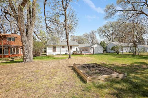 The raised garden invites you to plant veggies in the backyard.
