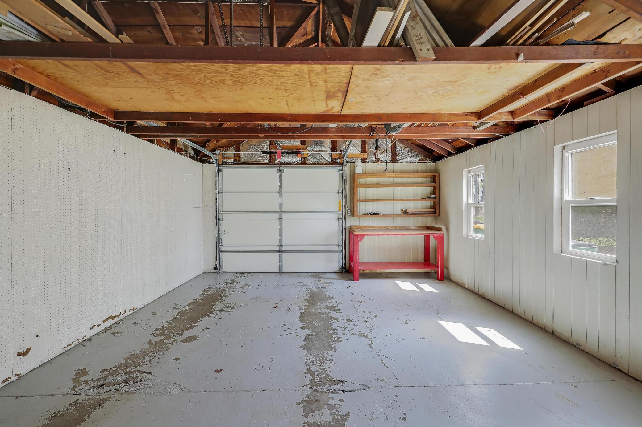 Garage with automatic opener, 2 daylight windows and space for a work station or extra storage.